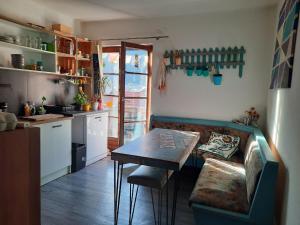 a kitchen with a table and a couch in a room at Gasthof Hirschen in Pfunds