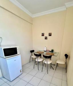 a kitchen with a table and chairs and a microwave at MEK HOMEs 2 in Fethiye