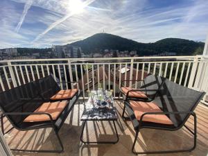 a balcony with two chairs and a table on a balcony at Villa Mar Vintage Apartments in Dubrovnik