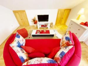 a red couch with pillows in a living room at Villa Mar Vintage Apartments in Dubrovnik +24 photos