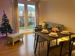 a living room with a table and a christmas tree at beautiful 2 bedrooms flat for family in Portsmouth