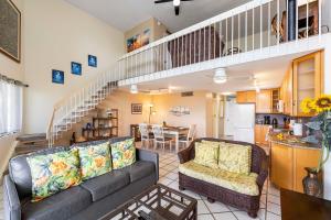 a living room with a couch and a table at Kona Alii 512 in Kailua-Kona
