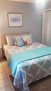 a bedroom with a bed with pillows on it at Scenic Views, Hot Tub, Balcony, And Beach Time! in Pensacola