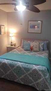 a bedroom with a bed with a ceiling fan at Scenic Views, Hot Tub, Balcony, And Beach Time! in Pensacola
