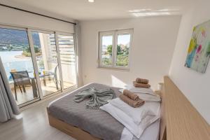 Postel nebo postele na pokoji v ubytování Apartments Holidays Roko
