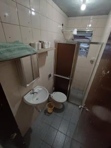 a small bathroom with a sink and a toilet at Vila Olímpia - Econômica in Sao Paulo