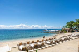 a beach with lounge chairs and the ocean at OMP 15C-T2, Seaview, Free Pool & Beach Access, Near Airport, FAST WI-FI, Netflix in Punta Engaño