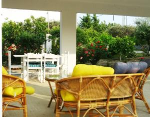 a patio with chairs and a table and a table and chairs at Nadia's House 1 in Afantou