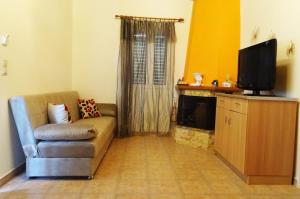 a living room with a couch and a television at Nadia's House 1 in Afantou +15 photos