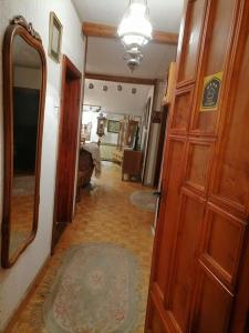 a hallway with a wooden door and a mirror at Apartment Relax in Zrenjanin