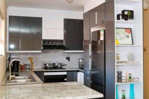 a kitchen with a stainless steel refrigerator and a sink at Modern Rental Flat in Maseru in Maseru