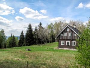 a small house on a hill in a field at Chalet Sluneční vršek by Interhome in Horní Polubný