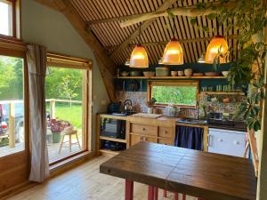 a kitchen with a wooden table in a room at Green Valley Cabin in Dorchester