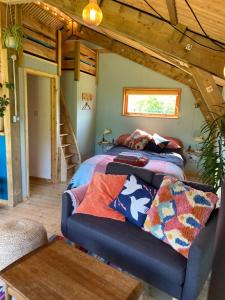 a bedroom with a bed and a couch in a room at Green Valley Cabin in Dorchester