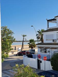 a view of the beach from a building with a stop sign at Dúplex 4, primera línea de Playa in Sanlúcar de Barrameda