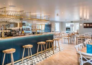 a restaurant with a bar with stools at Ribblesdale Lodges in Gisburn