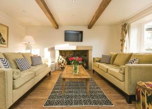 a living room with two couches and a fireplace at Ribblesdale Lodges in Gisburn