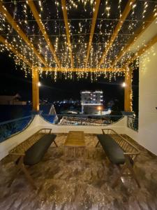 a stage with chairs and a table and lights at Trà My Villa Đà Lạt BBQ Garden - Nguyên Căn Có Sân Vườn in Da Lat