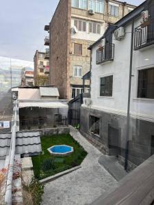 an apartment with a courtyard with a small pool at Blur Inn Gallery in Yerevan
