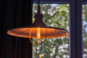 an orange light hanging from a window at Comfortable and Modern Orange Studio in Warsaw by Renters in Warsaw