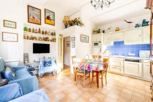 cocina y sala de estar con mesa y sillas en Gite de la Maison du Gabelou, en La Barre-de-Monts