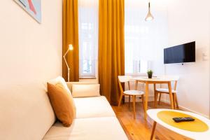 a living room with a couch and a table at Cosy Apartment Koliste 25 in Brno