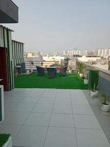 a balcony with chairs and a view of a city at Amahi Inn - Sector 48 in Gurgaon