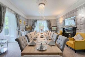 a dining room with a long table and chairs at Mount Eagle - Sleeps 24 in Limerick