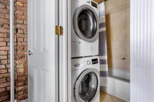 two washing machines and a washer and dryer in a room at West Village 2br w wd nr shopping NYC-1274 in New York