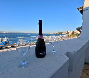a bottle of wine and two wine glasses on a ledge at Il Palazzino in Taranto