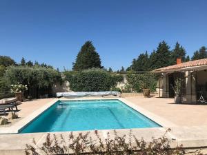 a swimming pool in the backyard of a house at Lou Mas dou Souleou & Spa in Cheval-Blanc