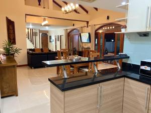 a kitchen and living room with a counter top at Pattaya Beach Pool Villa At Pattaya in Pattaya South