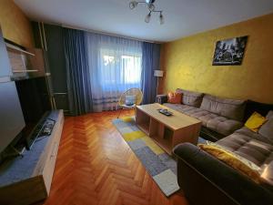 a living room with a couch and a table at Apartman TaMaRa in Doboj