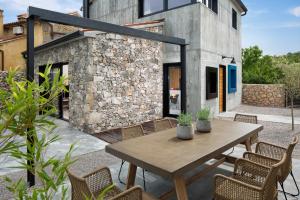 a patio with a wooden table and chairs at Villa Iron Lady in Labin