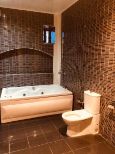 a bathroom with a bath tub and a toilet at ART inn hotel in Baku