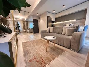 a living room with a couch and a table at Elegance in Bucharest