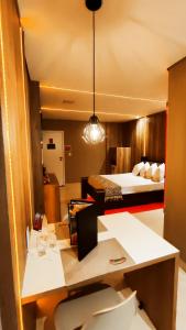 Zimmer mit 2 Betten und einem Schreibtisch in einem Zimmer in der Unterkunft Motel Exótico Prime - Próximo GRU Aeroporto in Itaquaquecetuba