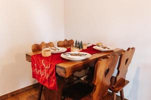a dining room table with a red table cloth on it at Little Bear Lodge in Sibiu