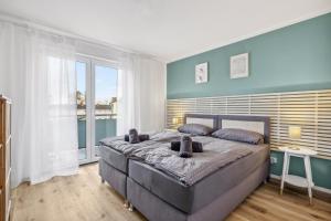 1 dormitorio con 1 cama grande y ventana grande en Amalfi A02 - 2 Zi für 4P - Balkon, smart TV, Boxspringbett, en Kaiserslautern