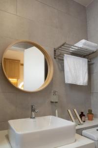 a bathroom with a sink and a mirror at The Nest at The Shore KK CBD Seaview with Balcony in Kota Kinabalu