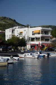 a group of boats docked in the water in front of a building at Holidays Roko - Sea View Apartments with Pool in Grebaštica +49 photos