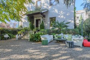 a patio with couches and tables in front of a building at Villa Aida in Milan