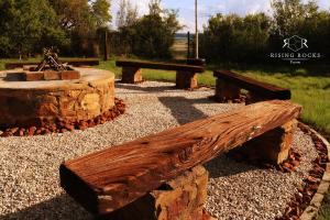 a group of wooden benches in a park at Tranquil Mountain Cottage :Hikes/Boma/Animals/Pool in Magaliesburg