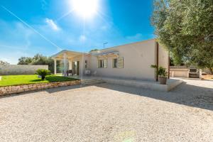 a house with a gravel driveway in front of it at Villa Angi by Perle di Puglia in San Vito dei Normanni