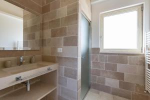 a bathroom with a sink and a window at Villa Angi by Perle di Puglia in San Vito dei Normanni +20 photos