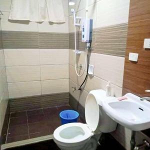 a bathroom with a shower and a toilet and a sink at Wow unit 2 for 6 guests up to 8 in Baguio +13 photos