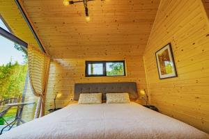 a bedroom in a log cabin with a bed at Saint Constantine Mountain Retreat in Peshtera