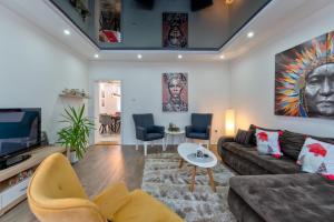 a living room with a couch and a tv at White House NS in Novi Sad