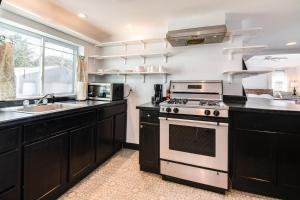 a kitchen with a stove and a sink at Room 10 Boutique Hotel, Balsam Lake Wi in Balsam Lake