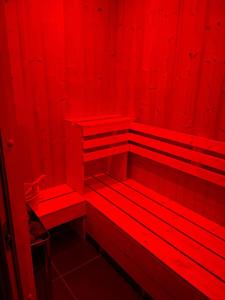 a red room with red benches in it at Maison Dépendance Privative in Benfeld